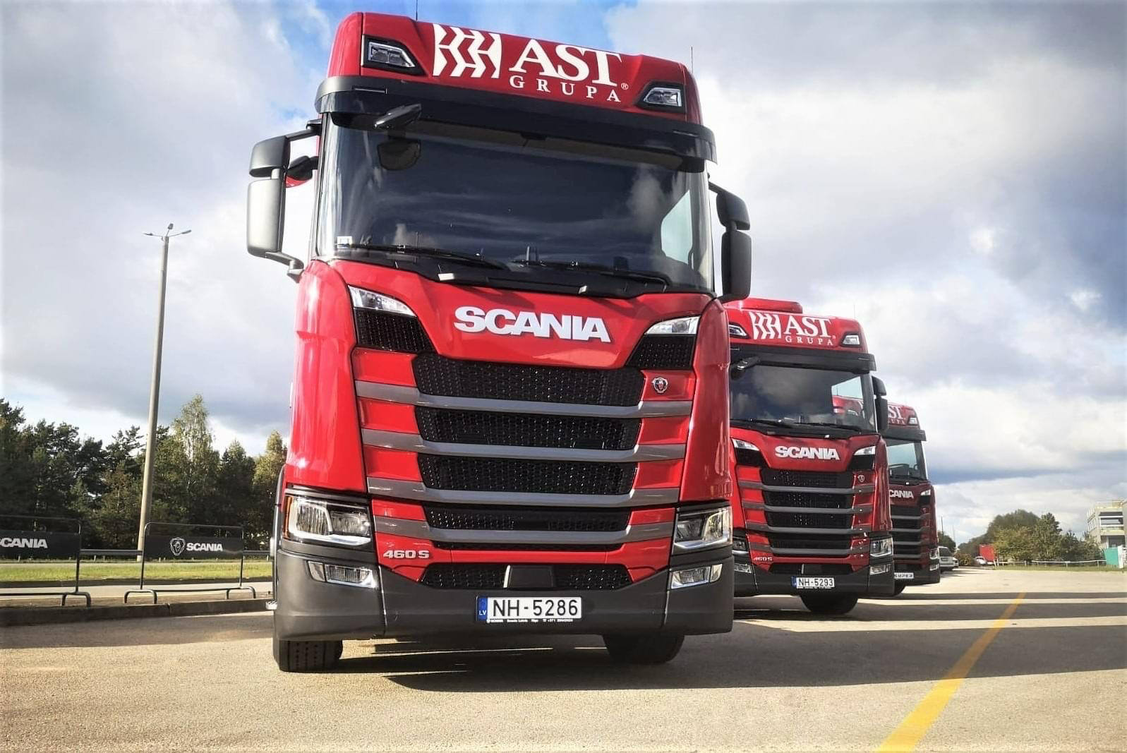 Red AST Grupa trucks on a road